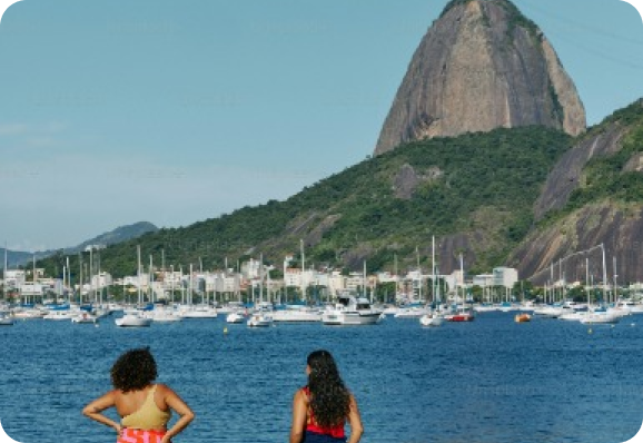 People in a beach, looking at the sea.